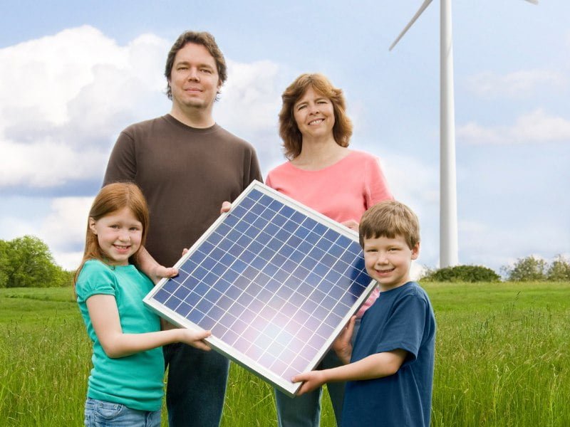 Família segurando painel solar.