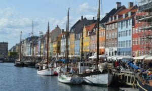 barcos em rio com casas ao lado